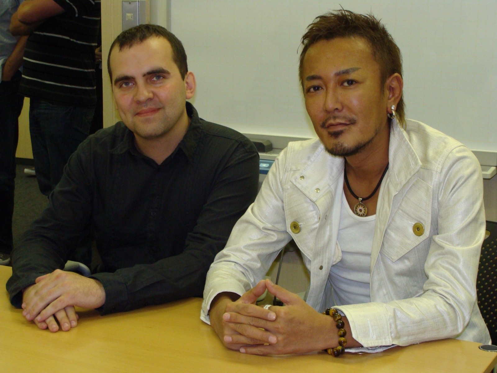 Michal Mazur meeting game creator Toshihiro Nagoshi during an interview.